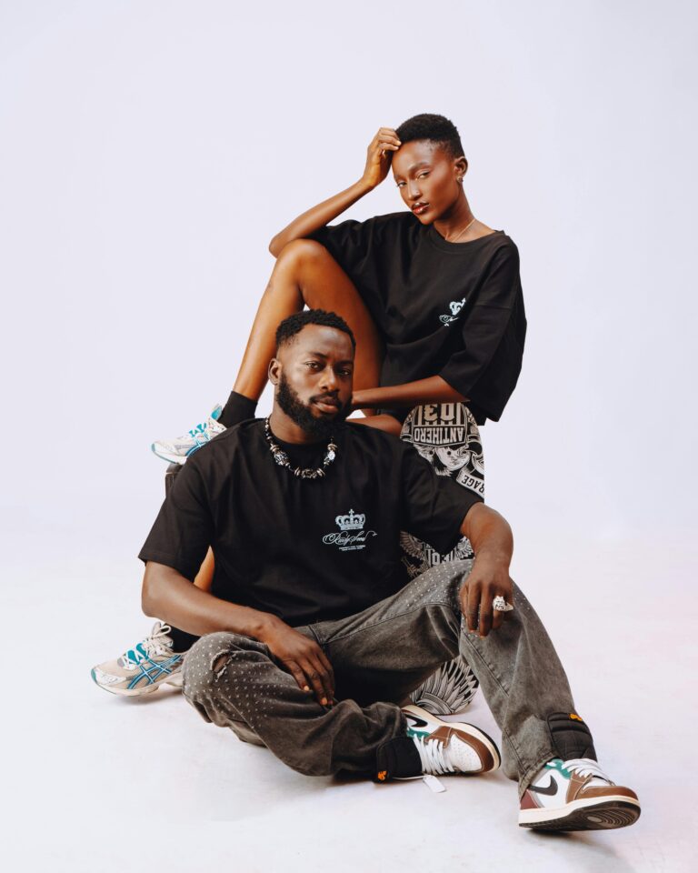 Chic urban fashion portrait of young adults in trendy streetwear posing with confident expressions.